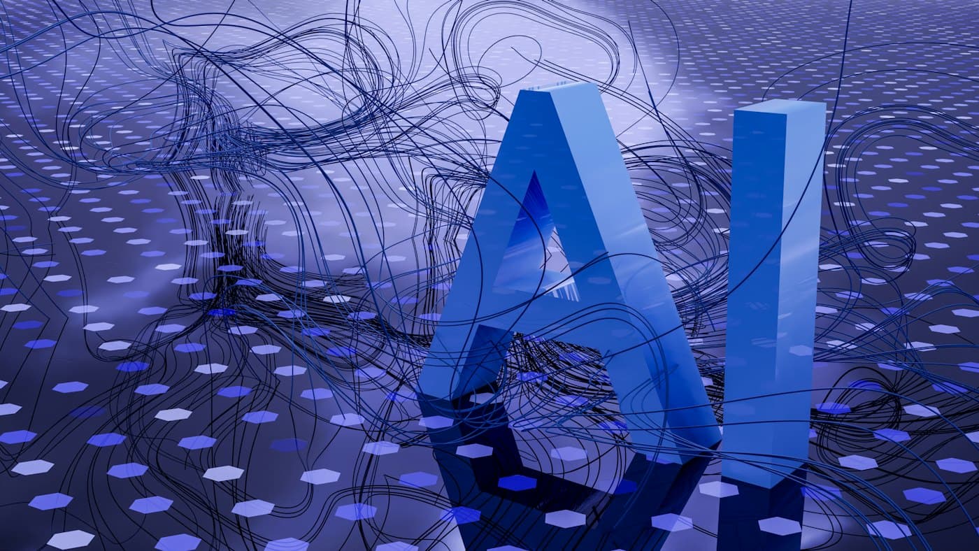 Large blue 3D letters spelling AI on a textured surface