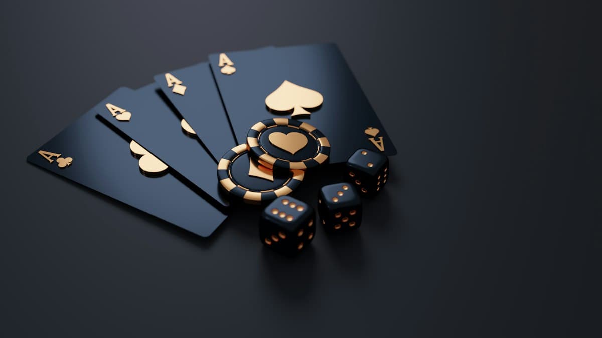 Black and gold playing cards with chips and dice