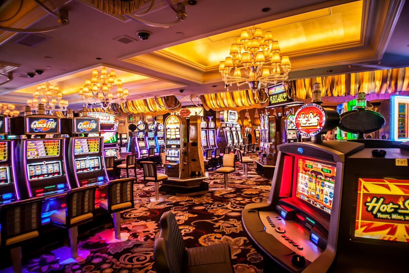 Rows of illuminated slot machines on a casino floor