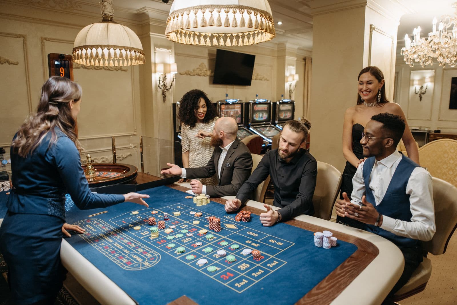 Players placing bets around a roulette table in a casino