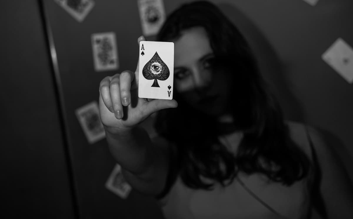 Woman holding up the ace of spades