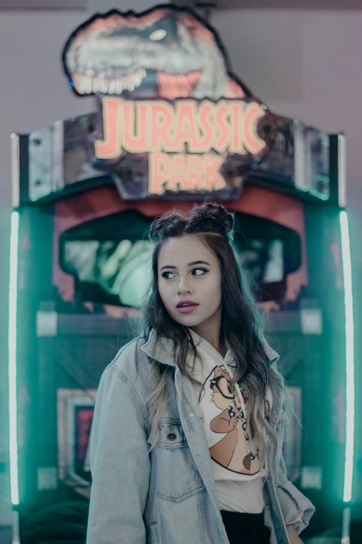 Girl standing in front of an arcade machine