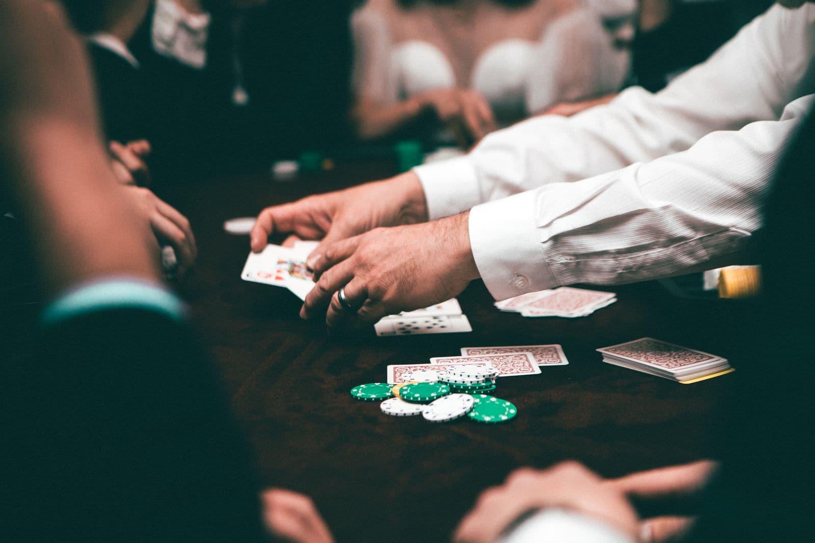 Players pushing chips into the pot at a poker table