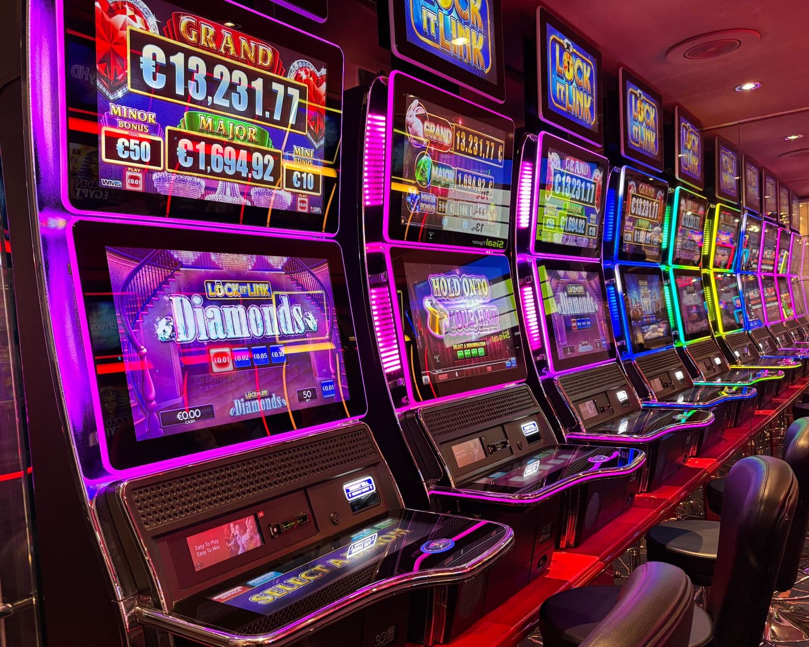 Row of neon-lit video slot machines