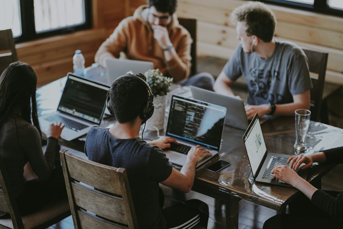 The team working together on laptops around a table